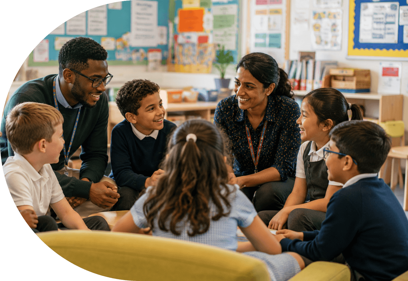A teacher and pupils talking supportively in a primary school classroom